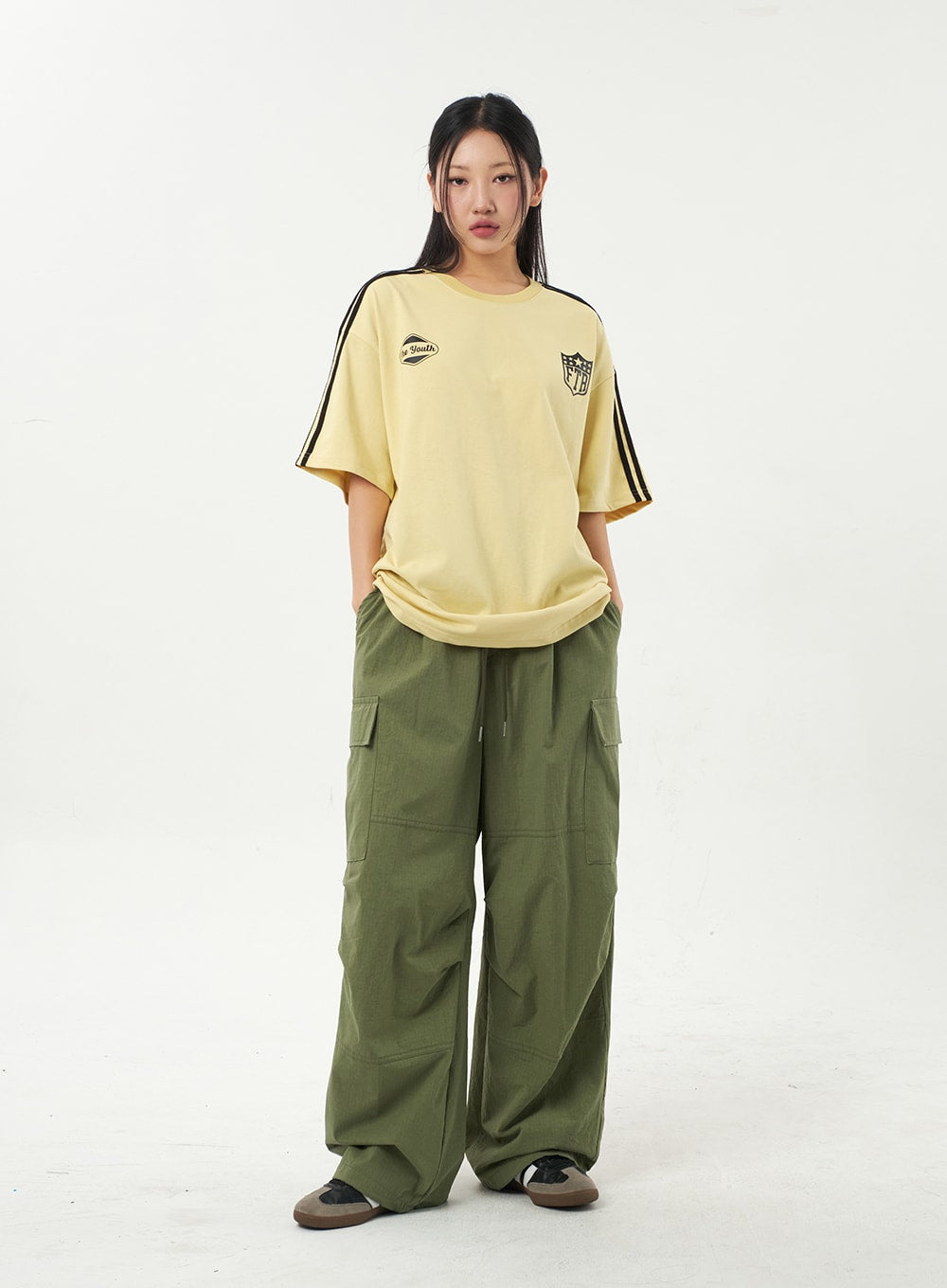 Girl In Green Cargo Pants And A T-shirt Stock Photo, Picture And Royalty  Free Image. Image 133038150.