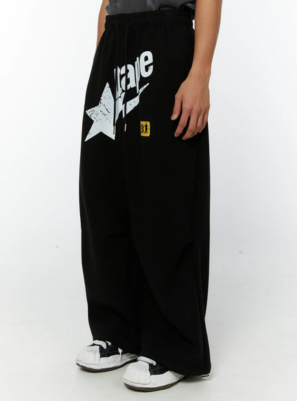 mens-graphic-parachute-string-sweatpants-black-iy513